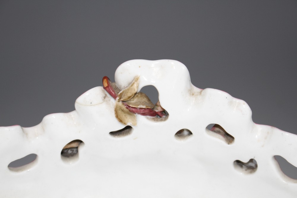 An early 20th century German porcelain centrepiece, with floral encrusted bowl supported by three children, height 28.5cm, width 44cm